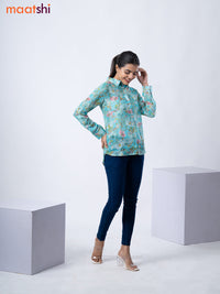 Women's shirt teal blue with allover floral prints and collar neck pattern