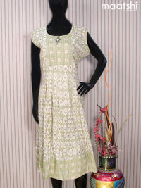 Rayon readymade umbrella kurti cream and green with allover prints & simple neck pattern without pant