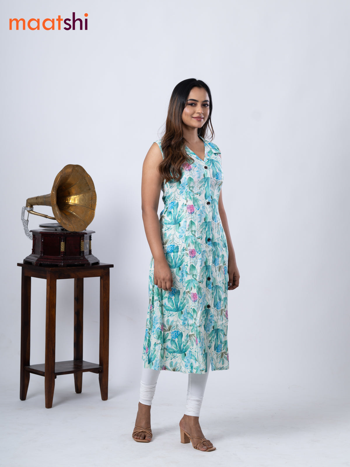 Rayon A-line kurti cream and teal green shade with allover prints & thread weaves collar neck without pant & sleeve attached