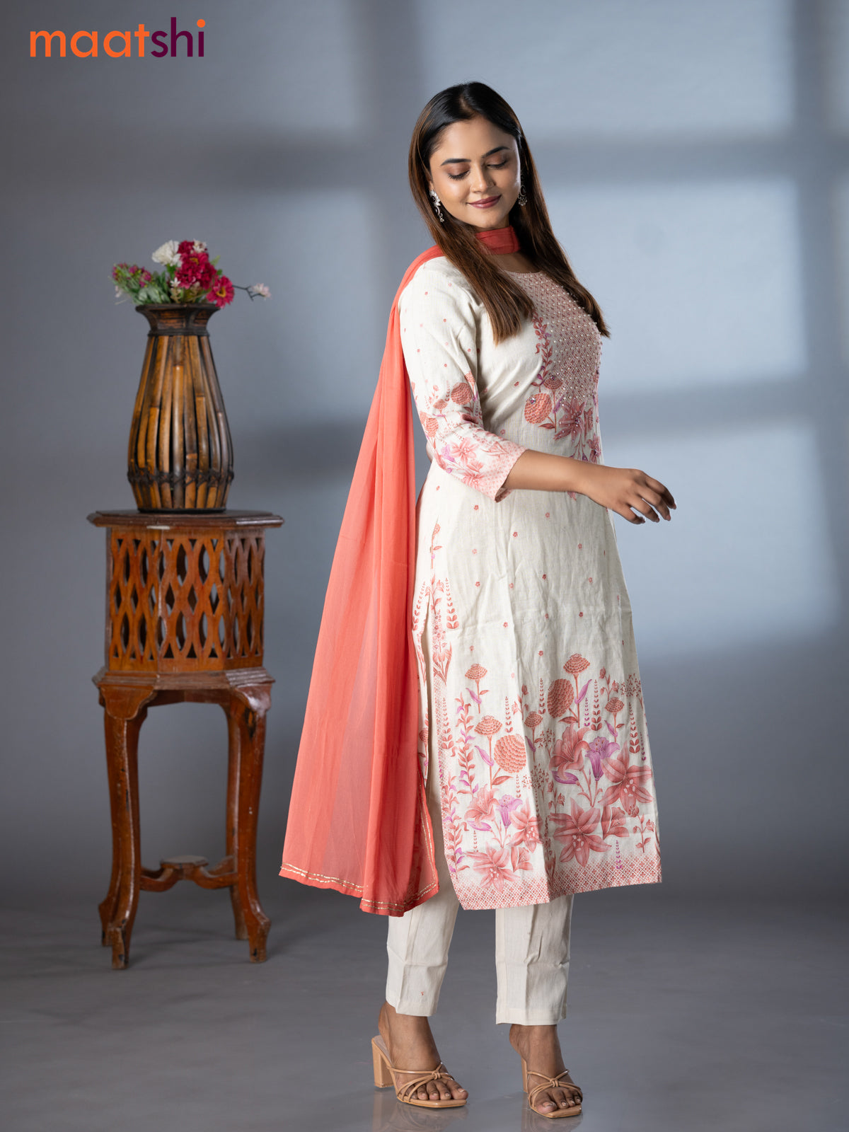 Placement prints readymade salwar suit off white and peach shade with floral prints & sequin beaded work neck pattern and straight cut pant & chiffon dupatta