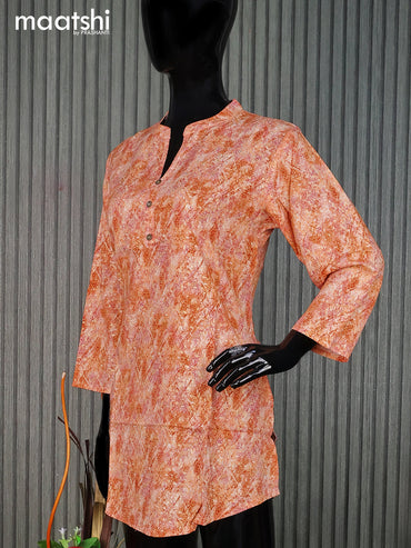 Cotton readymade short kurti pale orange with allover prints & simple neck pattern without pant