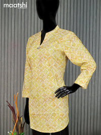 Cotton readymade short kurti pale yellow and off white with allover prints & simple neck pattern without pant