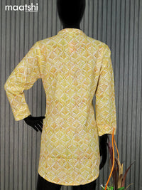 Cotton readymade short kurti pale yellow and off white with allover prints & simple neck pattern without pant