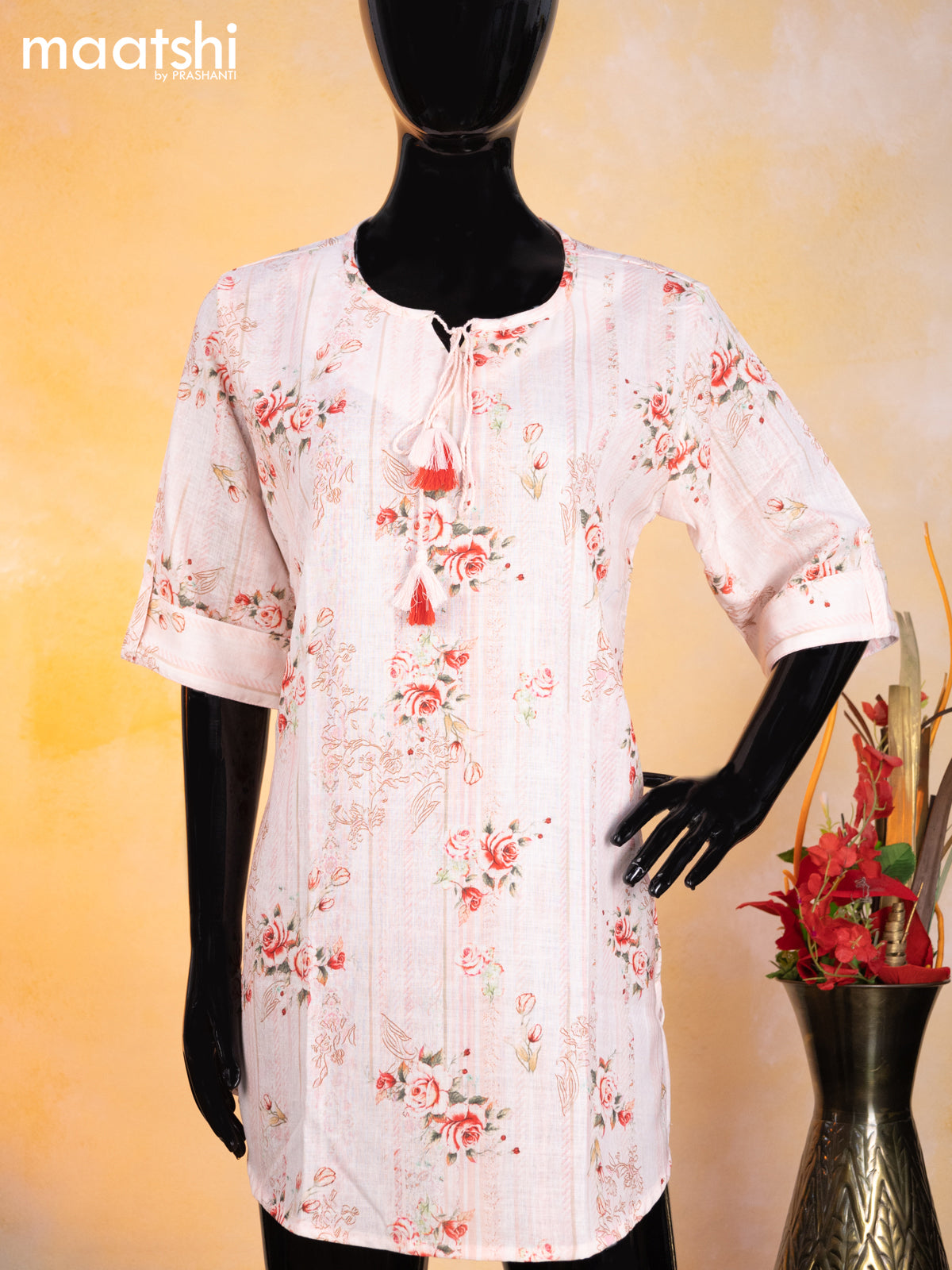 Cotton readymade short kurti mild peach with allover floral prints & simple neck pattern without pant