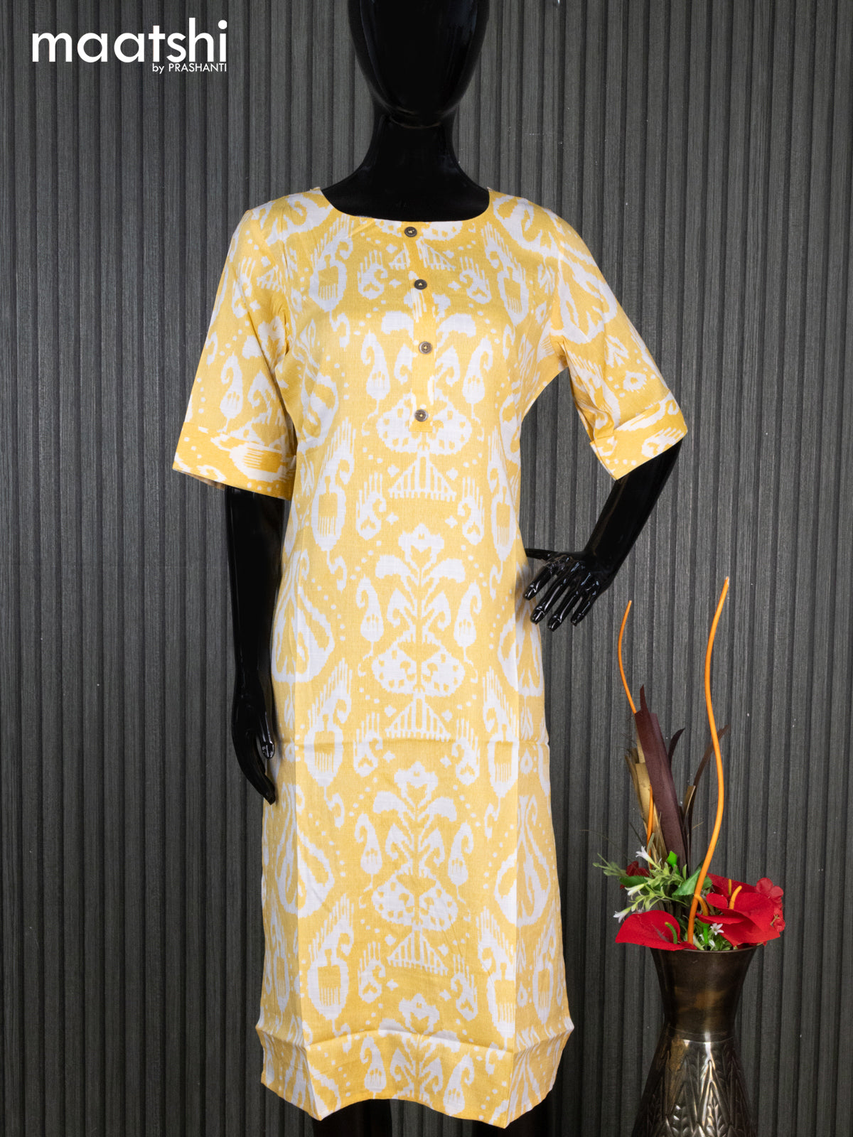 Rayon readymade kurti yellow and off white with allover ikat prints & simple neck pattern without pant