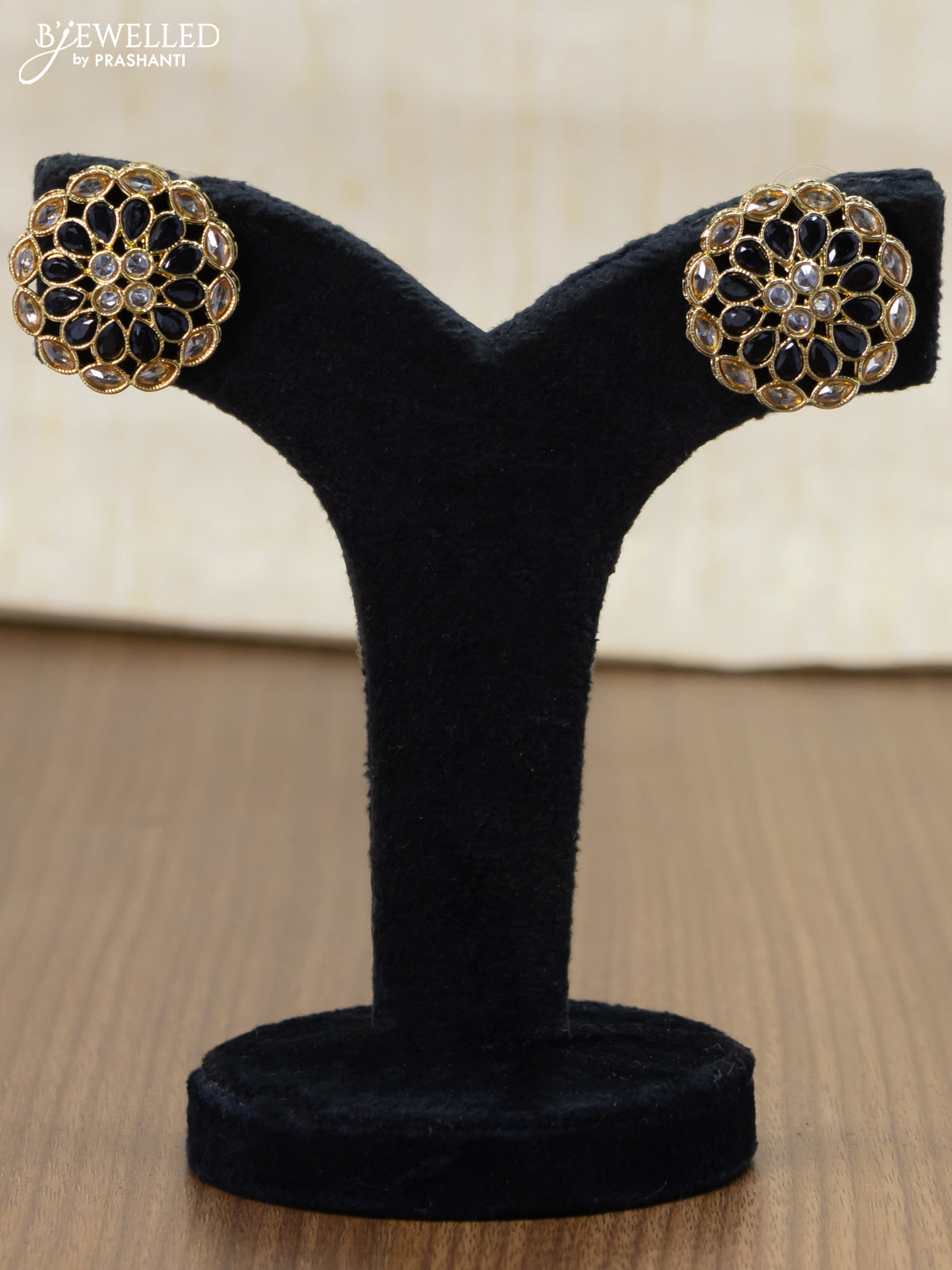 Light weight floral design earrings with cz and black stone