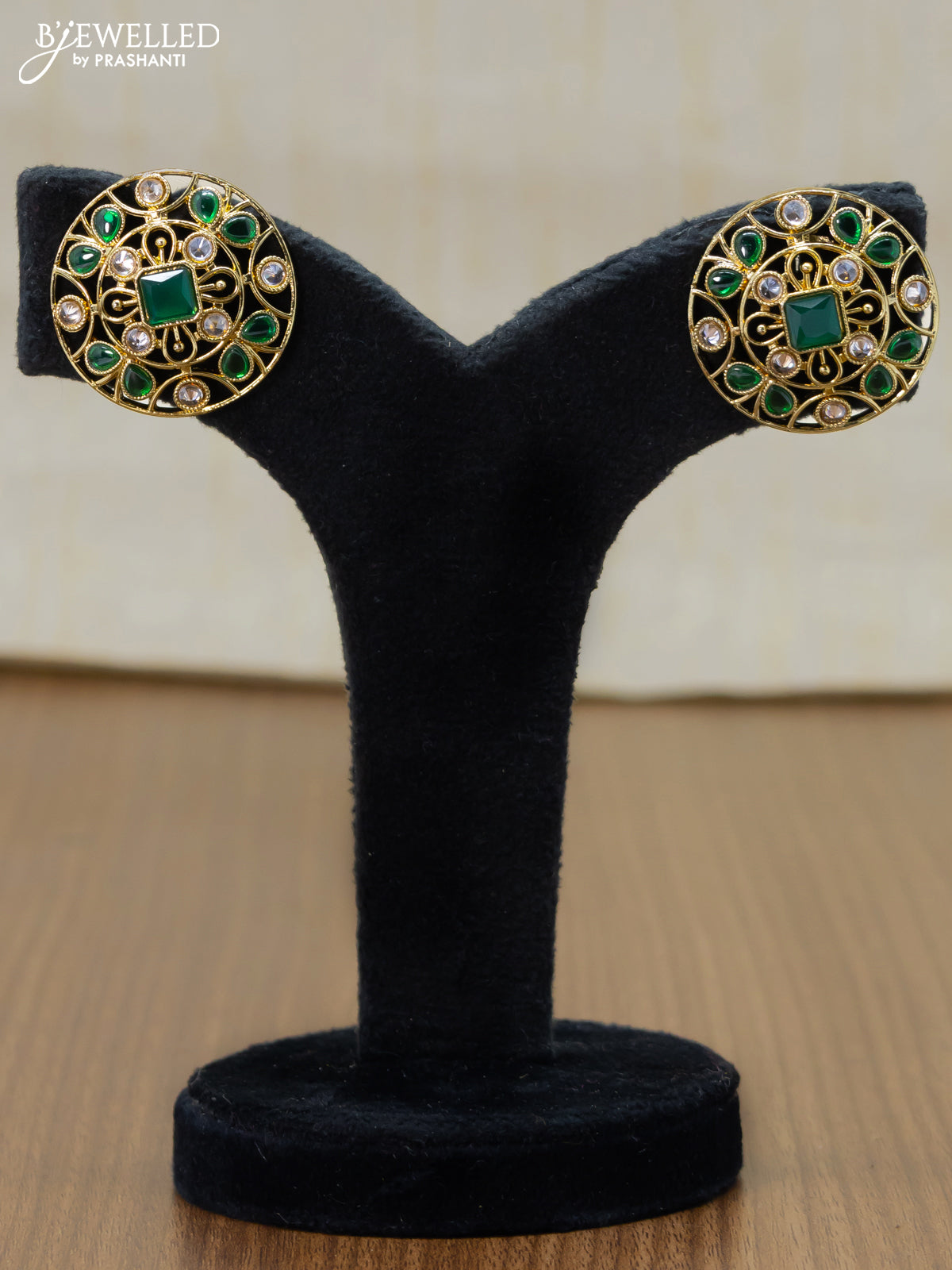 Light weight floral design earrings with cz and emerald stone