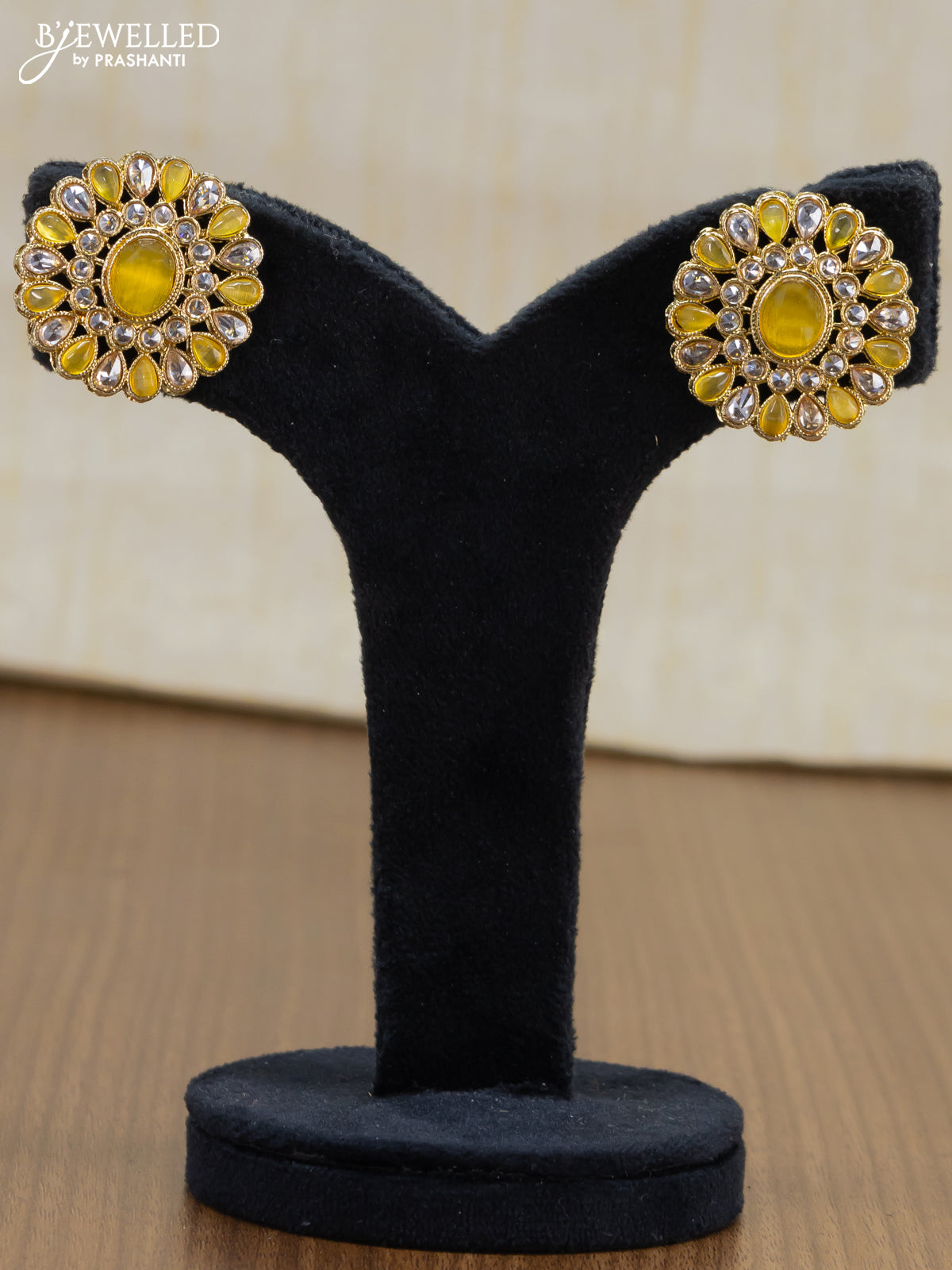 Light weight floral design earrings with cz and yellow stone