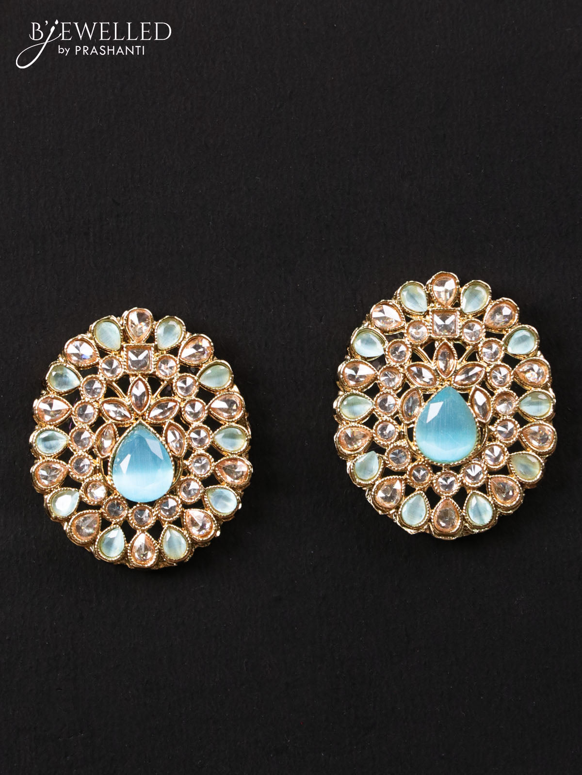 Light weight earrings with cz and light blue stone