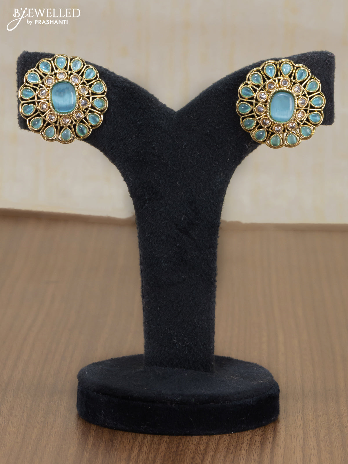 Light weight earrings with cz and light blue stone