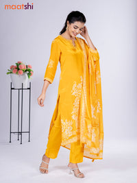 Crepe silk salwar suit mango yellow with placement prints & beaded work neck pattern and straight cut pant & dupatta