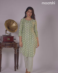 Cotton kurti sap green and off white with allover ikat prints & simple neck pattern and straight cut pant