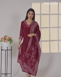 Crepe silk salwar suit deep maroon with placement prints & beaded work v neck pattern and straight cut pant & dupatta