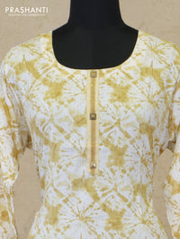 Slub cotton readymade kurti off white and mustard with allover batik prints simple neck work and straight cut pant