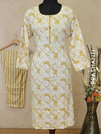 Slub cotton readymade kurti off white and mustard with allover batik prints simple neck work and straight cut pant